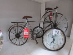 A bicycle clock and a penny farthing clock