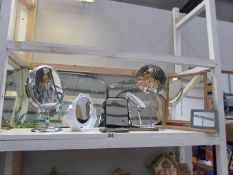 A shelf of various mirrors