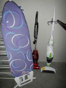 A modern ironing board and 2 cleaners