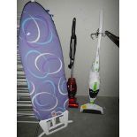 A modern ironing board and 2 cleaners