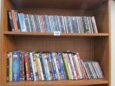 2 shelves of dvds and cds