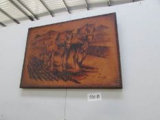 A leather picture of horses ploughing