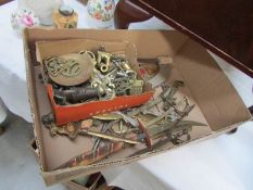 A box of brassware including paper knives