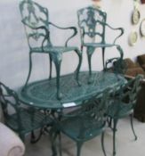 A green garden table and 6 chairs