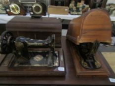 A Jones sewing machine in case and a Singer sewing machine in case
