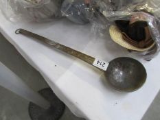 Vintage hammered copper ladle with a worn nickel plated finish