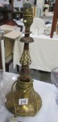 An Eastern brass and wood table lamp