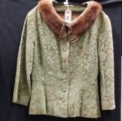 A vintage green lace jacket with fur trim