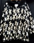 A Zandra Rhodes zip up knitted jacket in black, white and gold,