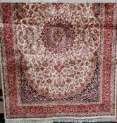 A beige ground kesham carpet,