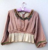 A beaded vintage cream and pink blouse