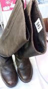 A pair of brown leather knee length boots with back zip,