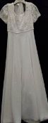 A 'Mon Cheri Bridal Inc' ivory wedding gown with beaded bodice and train,