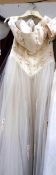 An ivory 'Cheri Bridal Inc' gown with fitted decorative bodice and full net skirt,