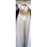 An ivory 'Cheri Bridal Inc' gown with fitted decorative bodice and full net skirt,