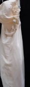 A 'Crystal Breeze' cream gown with side drape detail,