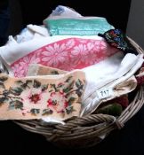 A wash basket of linens including cushion covers