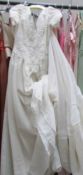 An ivory 'Mon Cheri Bridal's Inc' wedding gown with train,