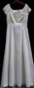 A slimfit 'Alfred Angelo' ivory wedding gown with beaded bodice,