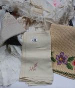 A box of vintage household linen and cloths