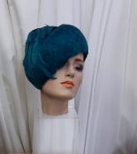 A vintage turquoise feather hat