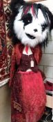 A panda head and a red theatrical costume,