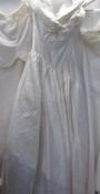 An ivory wedding gown with fitted bodice and full skirt,