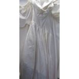 An ivory wedding gown with fitted bodice and full skirt,