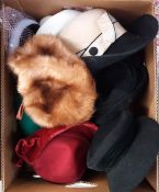 A box of various vintage and contemporary hats