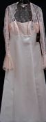 A soft peach gown with lace bolero and front bodice,