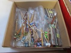 A box of assorted lace bobbins