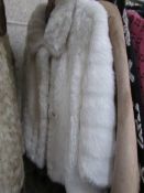 A white fur astraka jacket,