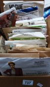 A box of assorted vintage sewing patterns