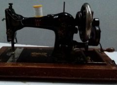 A vintage sewing machine with box and key