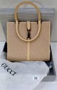 A boxed Gucci bag,