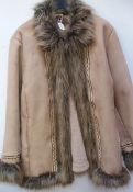 A faux sheepskin jacket with embroidery and fake fur trim