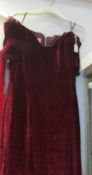 A red velvet evening gown with small pouch bag,