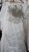 An ivory wedding gown with full skirt, bead and sequin bodice,