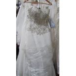 An ivory wedding gown with full skirt, bead and sequin bodice,