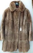 A ladies quality musquash fur coat with half belt