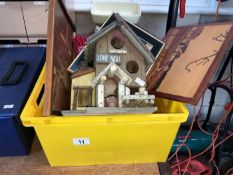 A box of wooden items including a bird house