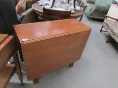 A teak drop leaf table