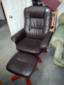 A brown swivel chair & matching foot stool
