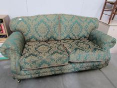 A good quality green patterned sofa