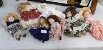 7 miniature porcelain dolls