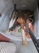 A box of sports equipment including cricket bats,