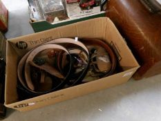 A box of leather belts etc