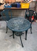 A metal table and 2 chairs