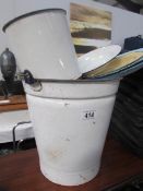 An enamel bucket and other enamel ware