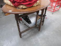 An oak barley twist gate leg table